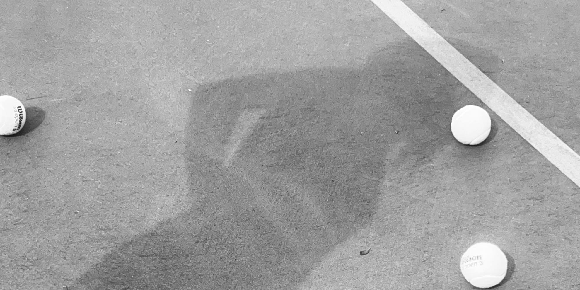 A player's shadow across the service box, balls where they landed